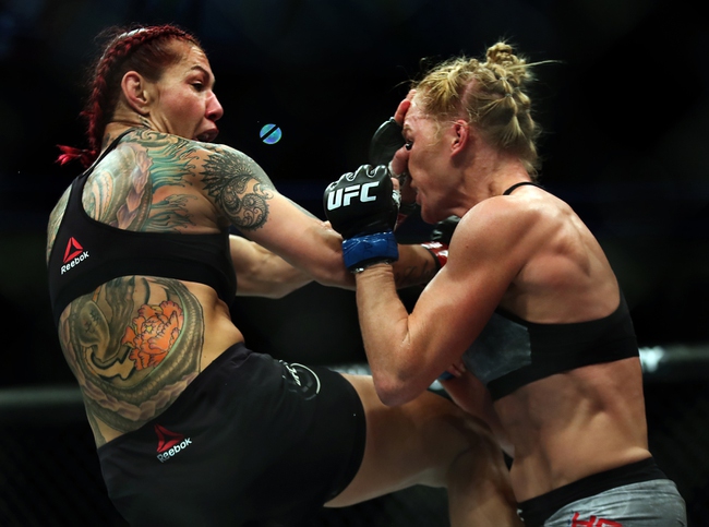 Womens Featherweight Cris Cyborg drives a knee and hand into Holly Holm during their UFC219 fight at the T-Mobile Arena on Saturday, Dec. 30, 2017.