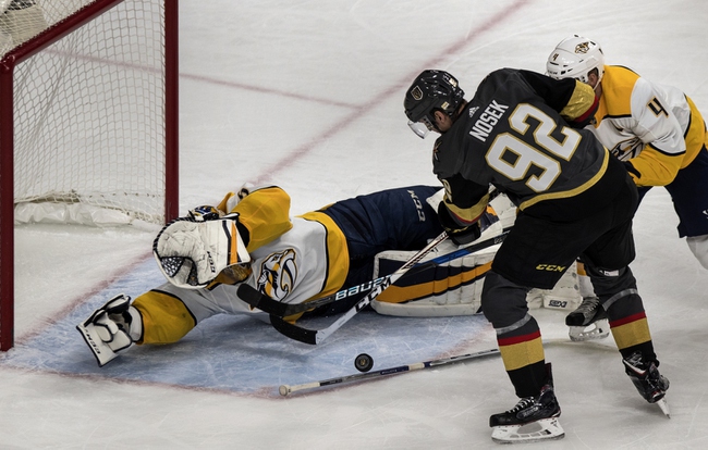 Vegas Golden Knights left wing Tomas Nosek (92) attempts a shot on goal as Nashville Predators goaltender Pekka Rinne (35) dives to protect it during their game at the T-Mobile Arena on Tuesday, Jan. 2, 2018.