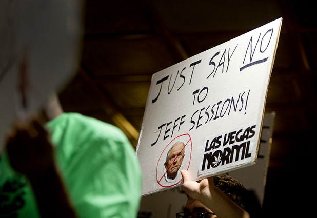 Chris Thompson holds up a sign during a news conference at the Apothecary Shoppe marijuana dispensary on West Flamingo Road Thursday, Jan. 04, 2018.