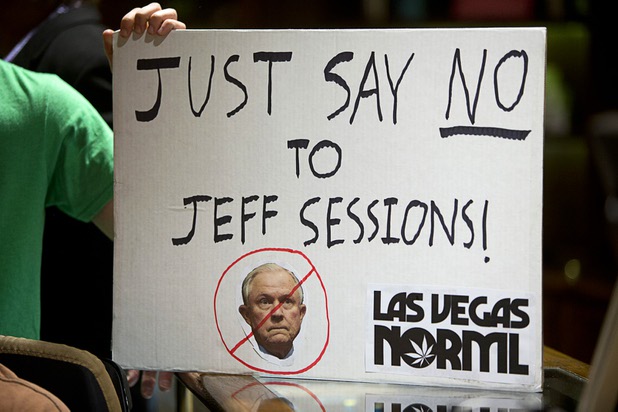 Chris Thompson holds up a sign during a news conference at the Apothecary Shoppe marijuana dispensary on West Flamingo Road Thursday, Jan. 04, 2018.