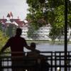 Visitors at the monorail station in front of Disney's Magic Kingdom theme park have a view of the Seven Seas Lagoon outside the Grand Floridian Resort & Spa Wednesday, June 15, 2016, in Lake Buena Vista, Fla.