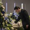 Former coworker Cristian Torres makes a final farewell during a remembrance service for LaTosha Juane White at the Unity Baptist Church, she one of two security officers recently killed by a gunman at Arizona Charlie's on Saturday, Jan. 6, 2018.