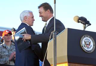 Vice President Mike Pence shakes hands with Sen. Dean Heller (R-Nev)as he is introduced during a visit to Nellis Air Force Base Thursday, Jan.11, 2018.