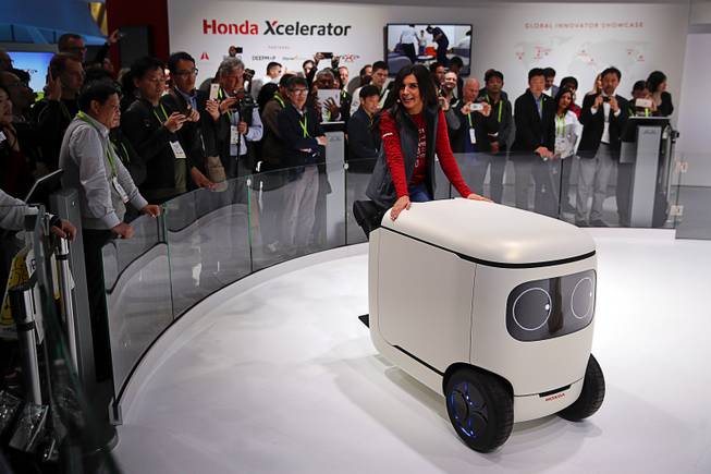 An exhibitor demonstrates the Honda robotics concept 3E-C18 at CES International, Tuesday, Jan. 9, 2018, in Las Vegas. 