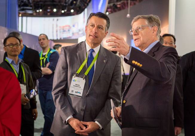 Nevada Governor Brian Sandoval, left, gets a tour of the Panasonic booth at CES by Peter Fannon, Vice President of Corporate, Government & Public Affairs, Panasonic Corporation of North America, Inc., at the Las Vegas Convention Center on Thursday, Jan. 11, 2018. CREDIT: Mark Damon/Las Vegas News Bureau