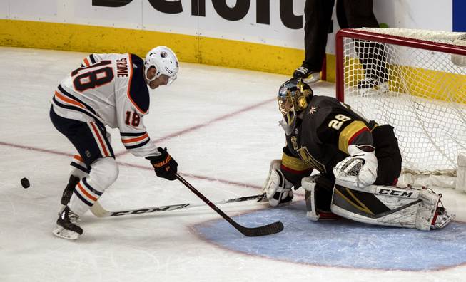 Edmonton Oilers center Ryan Strome (18) has a shot poked away by Vegas Golden Knights goaltender Marc-Andre Fleury (29) during their game at the T-Mobile Arena on Saturday, Jan. 13, 2018.  L.E. Baskow