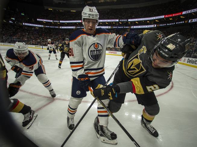 Edmonton Oilers left wing Drake Caggiula (91) and Edmonton Oilers left wing Drake Caggiula (91) tangle on the boards during their game at the T-Mobile Arena on Saturday, Jan. 13, 2018.  L.E. Baskow
