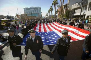 Members of Cheyenne High School's Junior Reserves Officers Training Corps (JROTC) carry an American flag during the annual Martin Luther King Jr. parade in downtown Las Vegas Monday, Jan.15, 2018.
