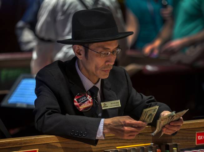 Craps employee Peter Dao counts some cash as the Golden Gate celebrates their 112th year anniversary on Saturday, Jan. 13, 2018.