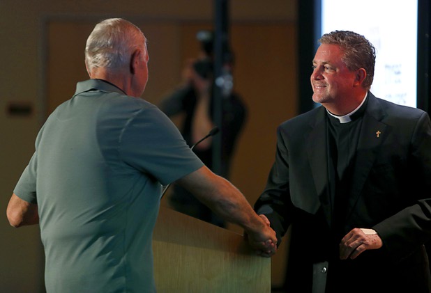Deacon Tom Roberts, right, president/CEO of Catholic Charities of Southern Nevada, greets Andrew Hustak, a former Catholic Charities of Southern Nevada client, during a news conference at the Three Square food bank Wednesday, Jan. 17, 2018. MGM Resorts International announced a surplus banquet food donation program they hope will provide 800,0000 meals by 2020.