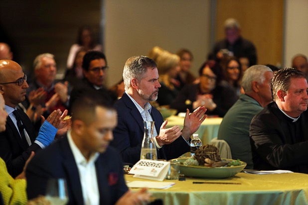 Jim Murren, center, chairman/CEO of MGM Resorts International, applauds during a news conference at the Three Square food bank Wednesday, Jan. 17, 2018. MGM Resorts announced a surplus banquet food donation program they hope will provide 800,0000 meals by 2020.