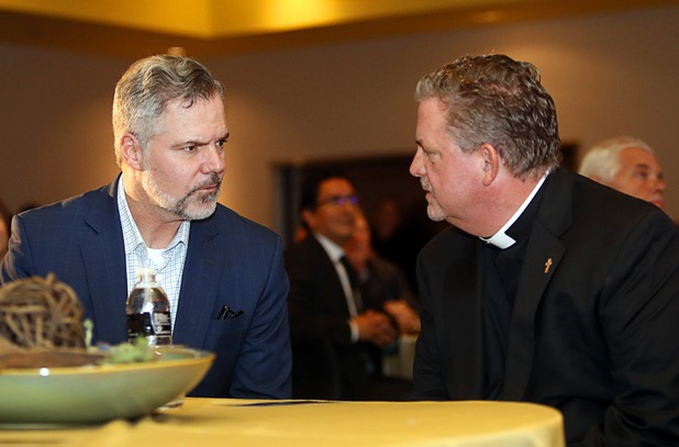 Jim Murren, left, chairman/CEO of MGM Resorts International, talks with Deacon Tom Roberts, president/CEO of Catholic Charities of Southern Nevada, before a news conference at the Three Square food bank Wednesday, Jan. 17, 2018. MGM Resorts announced a surplus banquet food donation program they hope will provide 800,0000 meals by 2020.