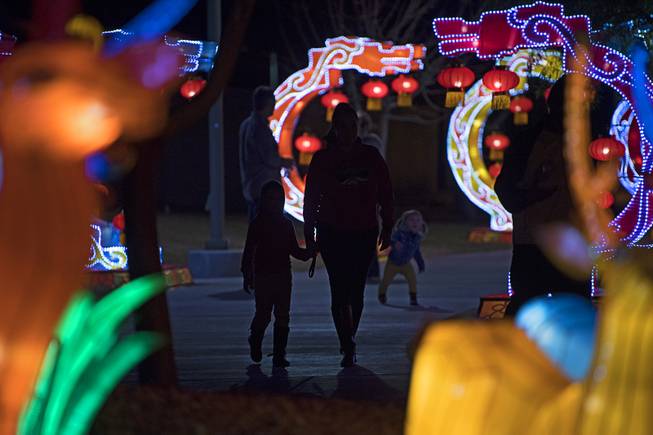 A woman walks hand in hand with a child on the opening night of the China Lights lantern festival Friday, January 19, 2018, at Craig Ranch Regional Park in North Las Vegas. The festival, which features nearly 50 silk and LED light displays comprised of over 1000 elements, runs through February 25th.