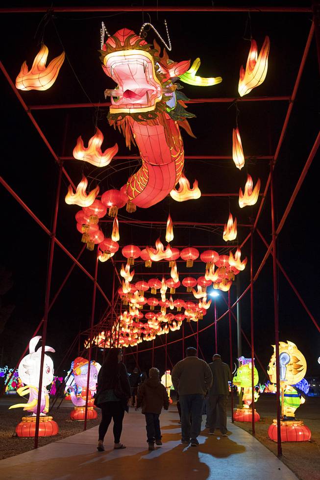 People walk under a flaming dragon on the opening night of the China Lights lantern festival Friday, January 19, 2018, at Craig Ranch Regional Park in North Las Vegas. The festival, which features nearly 50 silk and LED light displays comprised of over 1000 elements, runs through February 25th.