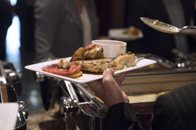 Guests get a sampling of a food that would be part of a banquet food "rescue" during an event announcing a partnership between MGM Resorts International and Three Square food bank to expand their surplus banquet food rescue program Wednesday, January 17, 2018.