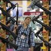 In this Jan. 17, 2013, file photo, Michael Kiefer, of DeFuniak Springs, Fla., checks out a display of rifles at the Rock River Arms booth during the 35th annual SHOT Show in Las Vegas.