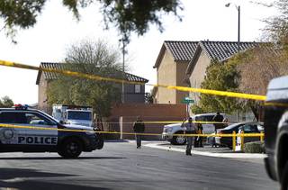 Metro Police and crime scene analysts investigate at the scene of an officer-involved shooting on Elcadore Street in a neighborhood near Las Vegas Boulevard and St. Rose Parkway Friday, Jan. 26, 2018.
