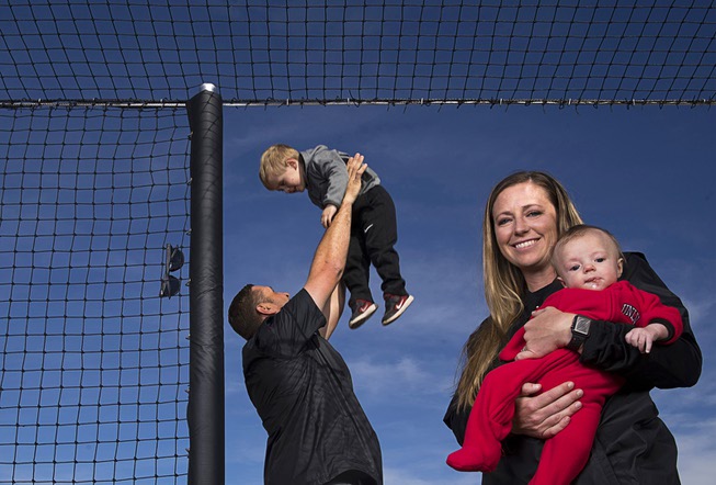 UNLV head softball coach Kristie Fox-Jarvis poses with her son ...