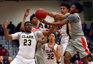 Clark High School and Bishop Gorman High School players fight for a rebound during a game at Clark High School Tuesday, Jan. 30, 2018. From left: Antwon Jackson (23), Isaiah Cottrell (0), Ian Alexander (32), Jalen Hill (21) and Zaon Collins (10). 