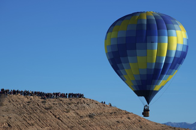 Spectators line a ridge to watch balloons during the Mesquite ...