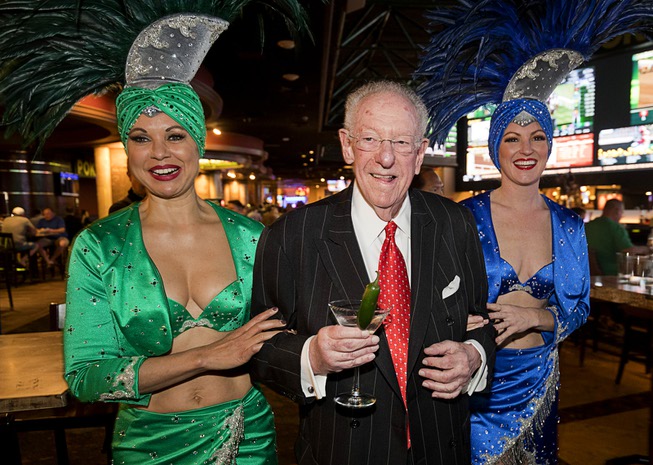 Former Las Vegas Mayor Oscar Goodman is accompanied by showgirls ...