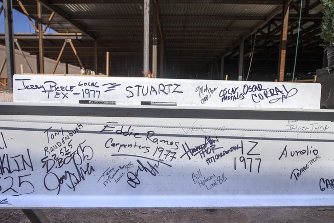 Signatures are seen on the final steel beam that will ...