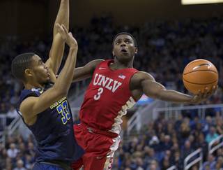 UNLV's Amauri Hardy shoots around Nevada's Josh Hall during the second half of an NCAA college basketball game in Reno, Nev., Wednesday, Feb. 7, 2018. (AP Photo/Tom R. Smedes)