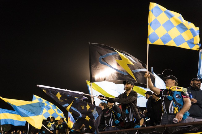 Fans cheer and wave giant flags during the Lights FC ...