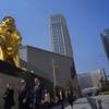 People walk past MGM Cotai Resort in Macau Tuesday, Feb. 13, 2018. MGM Resorts is opening a lavish multibillion-dollar casino resort in Macau, in the latest big bet by foreign gambling companies on the southern Chinese gambling haven. 