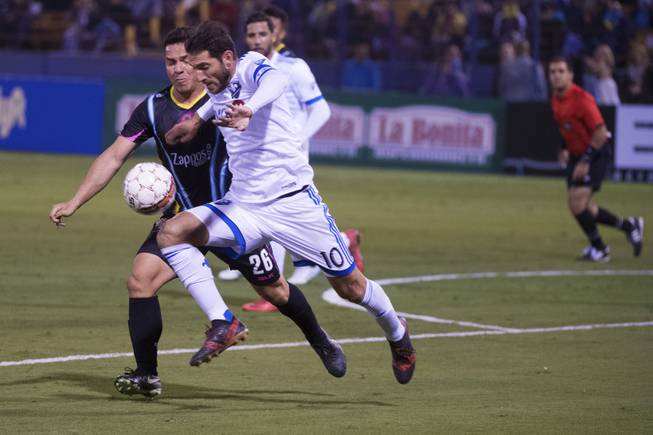 Las Vegas Lights Julian Portugal and Montreal Impact Ignacio Piatti compete for control of the ball during the Lights first exhibition game Saturday, February 10, 2018, at Cashman Field.