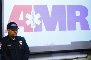 An AMR team member stands by during a press briefing Tuesday, Feb. 13, 2018 held to discuss details of an accident that caused the death of an AMR team member and a patient Monday night.