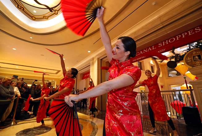 Dancers perform a Chinese fan dance during Year of the Dog celebrations at the Grand Canal Shoppes Friday, Feb. 16, 2018.