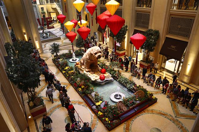 People wait for lion dancers in the Atrium at The Palazzo during Year of the Dog celebrations at the Venetian and Palazzo Friday, Feb. 16, 2018.