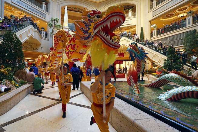 Performers arrive at the Atrium at The Palazzo during Year of the Dog celebrations at the Venetian and Palazzo Friday, Feb. 16, 2018.