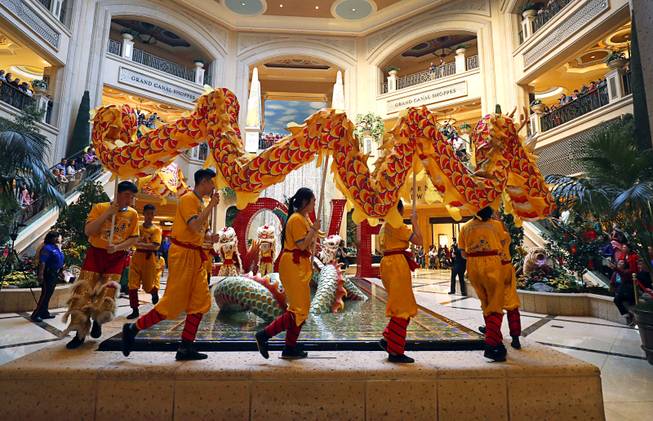 Performers carry a Chinese dragon in the Atrium at The Palazzo during Year of the Dog celebrations at the Venetian and Palazzo Friday, Feb. 16, 2018.