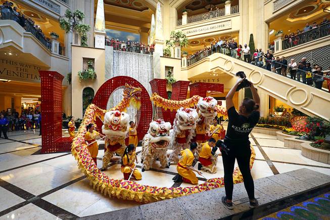 A photographer takes a photo of performers during Year of the Dog celebrations at the Venetian and Palazzo Friday, Feb. 16, 2018.