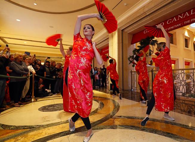 Dancers perform a Chinese fan dance during Year of the Dog celebrations at the Grand Canal Shoppes Friday, Feb. 16, 2018.