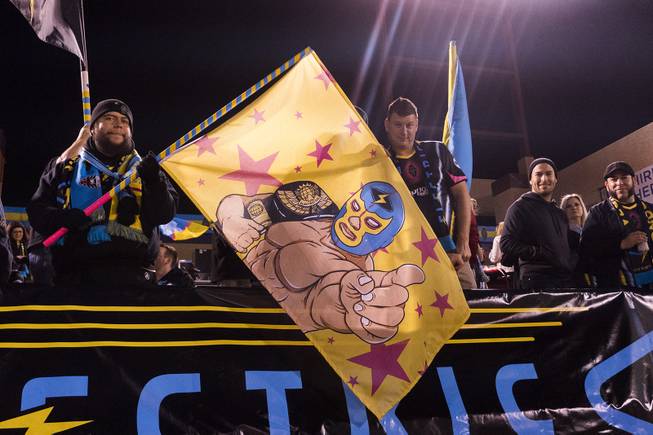 Fans wave a Lights luchador flag during the Lights spring training match against the Vancouver Whitecaps Saturday, February 17, 2018 at Cashman Field.