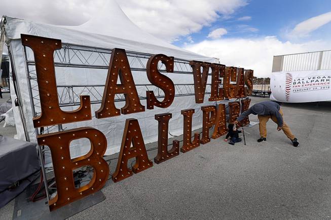 Joshua Brea poses his nephew David Carlin, 1, by a Las Vegas Ballpark sign during a groundbreaking ceremony for ballpark, a 10,000-fan capacity baseball stadium and future home of the Las Vegas 51s, in Summerlin Friday, Feb. 23, 2018.