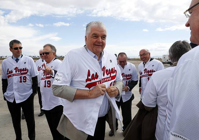 Clark County Commission Chairman Steve Sisolak, center, and other officials put on a jerseys during a groundbreaking ceremony for Las Vegas Ballpark, a 10,000-fan capacity baseball stadium and future home of the Las Vegas 51s, in Summerlin Friday, Feb. 23, 2018.