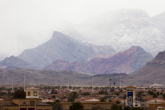 Snow falls in Red Rock Canyon as a cold front ...