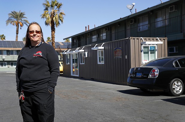 Wendy Grant, crisis intervention coordinator, poses outside a tiny home, made from a shipping container, at Veterans Village 2 near downtown Las Vegas Saturday, Feb. 24, 2018.  Veterans Village plans for an initial community of 11 tiny homes.