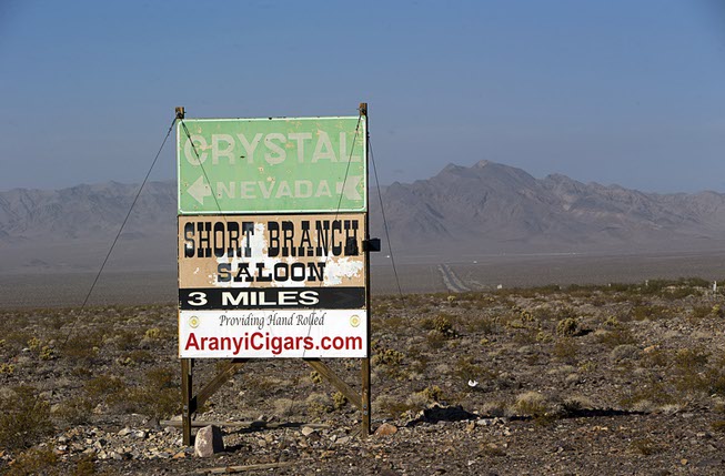 A sign by Highway 160 gives direction to Crystal, Nev. ...