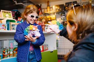 Esme Berger, 8, plays with unicorn puppets with her mother Miranda Berger at Kappa Toys located in Container Park, Downtown, Tuesday, Feb. 20, 2018.