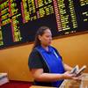 In this Aug. 20, 2015, file photo, Therese Duenas counts money as she takes bets in the sports book at the South Point in Las Vegas. 