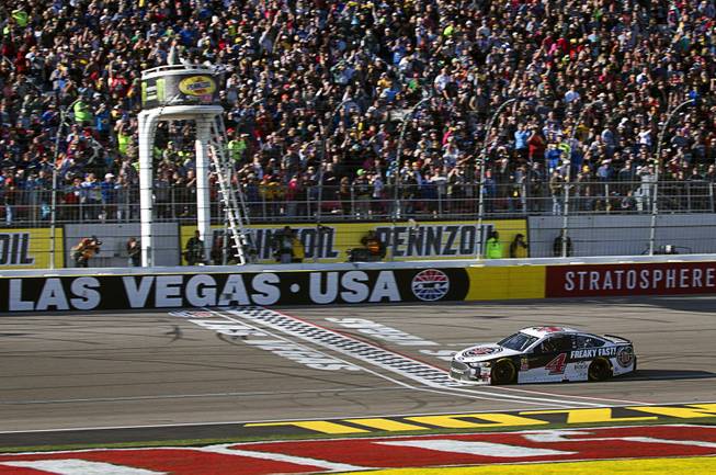 Kevin Harvick (4) crosses the finish line to win the ...