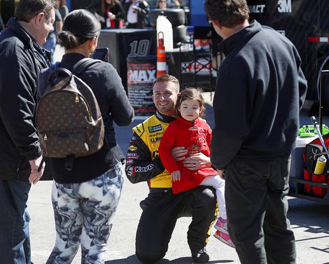 Driver Matt DiBenedetto poses with a fan before the NASCAR Pennzoil 400 race at the Las Vegas Motor Speedway Sunday March 4, 2018.