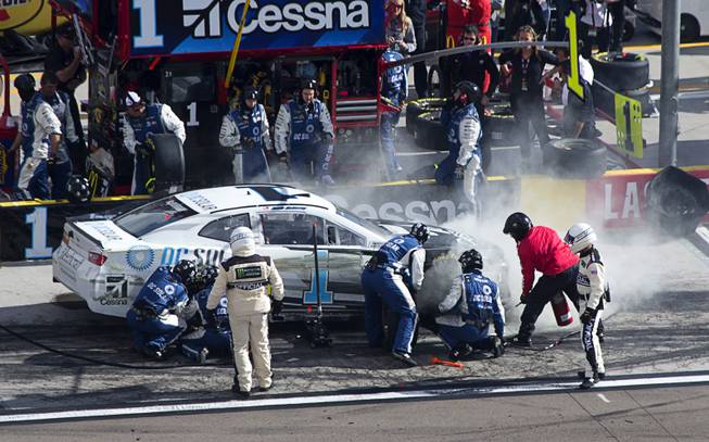 A pit crew examines the damaged car of driver Jamie McMurray (1) during the NASCAR Pennzoil 400 race at the Las Vegas Motor Speedway Sunday March 4, 2018.