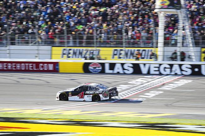 Driver Kevin Harvick (4) crosses the finish line to win ...