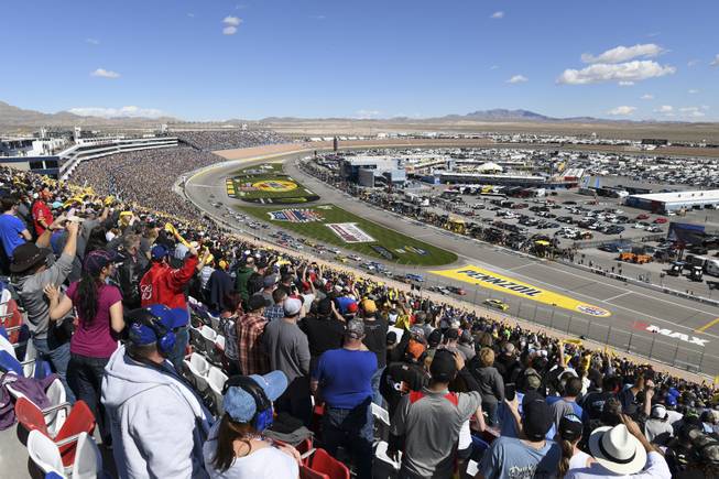 Fans wave Pennzoil flags at the start of the Monster Energy NASCAR Cup Series Pennzoil 400 Sunday, March 4, 2018, at the Las Vegas Motor Speedway.